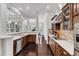 Well-appointed kitchen featuring stainless steel appliances, dark cabinetry, and counterspace at 1808 Pennypacker Ln, Durham, NC 27703