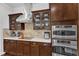 Gourmet kitchen with stainless steel appliances, sleek cooktop, and custom cabinetry at 1808 Pennypacker Ln, Durham, NC 27703