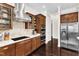 Modern kitchen with stainless steel appliances, rich wood cabinets, and ample counter space at 1808 Pennypacker Ln, Durham, NC 27703