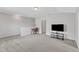 Bright loft area featuring neutral walls, carpet, a television, and a desk, suitable for an office at 1808 Pennypacker Ln, Durham, NC 27703