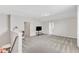 Open loft area with neutral walls, carpet, and a television, perfect for entertaining or relaxing at 1808 Pennypacker Ln, Durham, NC 27703