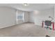 Loft with neutral carpet, a window, and a red desk setup at 1808 Pennypacker Ln, Durham, NC 27703