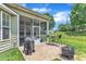 Cozy outdoor patio with a grill and seating area, leading to a screened-in porch for relaxed living at 1808 Pennypacker Ln, Durham, NC 27703
