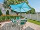 Back patio features brick pavers, outdoor seating, a sun umbrella, and mature landscaping at 1817 Wysong Ct, Raleigh, NC 27612