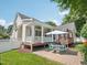 Inviting backyard patio with a covered deck, featuring an outdoor dining set for relaxing and entertaining at 1817 Wysong Ct, Raleigh, NC 27612
