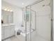 Bright bathroom featuring a glass-enclosed shower, jacuzzi tub, and dual sinks at 1817 Wysong Ct, Raleigh, NC 27612
