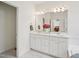 En-suite bathroom offers dual sinks, white cabinets, a large mirror, and access to the bathtub at 1817 Wysong Ct, Raleigh, NC 27612