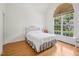 Bright, airy bedroom featuring vaulted ceilings, a large window, and hardwood floors at 1817 Wysong Ct, Raleigh, NC 27612