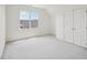 Bedroom with neutral carpet, large window, and spacious closet at 1817 Wysong Ct, Raleigh, NC 27612