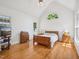 Spacious primary bedroom with vaulted ceilings, hardwood floors, and large windows at 1817 Wysong Ct, Raleigh, NC 27612