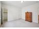 Neutral bedroom features neutral carpet, a spacious closet, and two entry doors at 1817 Wysong Ct, Raleigh, NC 27612