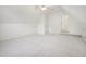 Bright bonus room features neutral carpet, a ceiling fan, and an entrance with stairs at 1817 Wysong Ct, Raleigh, NC 27612