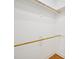 Walk-in closet with wooden rods and white shelving; ample storage space at 1817 Wysong Ct, Raleigh, NC 27612