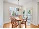 Bright breakfast nook featuring a chandelier and backyard views through large windows at 1817 Wysong Ct, Raleigh, NC 27612