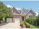 Beautiful two-story brick home with a manicured lawn, mature trees, and an attached garage at 1817 Wysong Ct, Raleigh, NC 27612