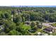 Aerial view of property in lush neighborhood with city skyline in distance at 1818 Cecil St, Durham, NC 27707