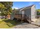 Back exterior of a home with a deck, fenced yard, and access to the basement at 1818 Cecil St, Durham, NC 27707