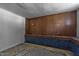 Basement room with wood paneled walls and concrete flooring at 1818 Cecil St, Durham, NC 27707