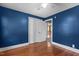 Cozy bedroom featuring hardwood floors, a ceiling fan, double closets, and a connecting room at 1818 Cecil St, Durham, NC 27707