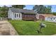 A charming single-story home, showcasing a screened porch, mailbox, and well-kept front lawn at 1818 Cecil St, Durham, NC 27707