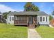 Charming single-story home featuring a screened front porch, gray siding, and a well-manicured lawn at 1818 Cecil St, Durham, NC 27707