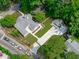 An aerial view of a charming home featuring a well-manicured lawn and an expansive driveway at 2100 Summit St, Durham, NC 27707
