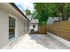 Backyard featuring a white brick home, fence, and an air conditioning unit at 2100 Summit St, Durham, NC 27707