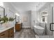 Spacious bathroom featuring double vanity, standalone tub, and a marble tiled walk-in shower at 2100 Summit St, Durham, NC 27707