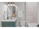 Bathroom vanity with modern fixtures, sleek mirror, and decorative vase with tile accent wall at 2100 Summit St, Durham, NC 27707