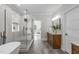 Modern bath featuring vanity, walk in shower, and soaking tub with natural light from nearby window at 2100 Summit St, Durham, NC 27707