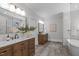 Spacious bathroom featuring double vanity, large mirrors, and a marble tiled walk-in shower at 2100 Summit St, Durham, NC 27707