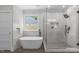 Luxurious bathroom featuring a soaking tub, glass enclosed shower, and modern tile at 2100 Summit St, Durham, NC 27707
