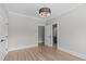 Bright bedroom featuring hardwood floors, decorative lighting and access to an ensuite bath at 2100 Summit St, Durham, NC 27707