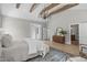Bright bedroom featuring wooden beams, stylish decor, and natural light from nearby windows at 2100 Summit St, Durham, NC 27707