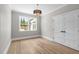 Empty bedroom with wood floors, natural light, and double doors at 2100 Summit St, Durham, NC 27707