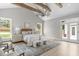 Vaulted ceiling bedroom with decorative rug, wooden beams, and natural light from large windows at 2100 Summit St, Durham, NC 27707