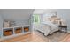 Charming bedroom with hardwood floors, natural light, built-ins and a comfortable bed at 2100 Summit St, Durham, NC 27707