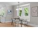 Bright dining area with large windows and a modern light fixture, perfect for gatherings at 2100 Summit St, Durham, NC 27707