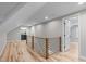 Hallway features hardwood floors, a modern railing, recessed lighting, and white trim at 2100 Summit St, Durham, NC 27707