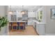 Modern kitchen with stainless appliances, white cabinetry, and a blue kitchen island at 2100 Summit St, Durham, NC 27707