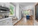 Bright, modern kitchen featuring stainless steel appliances, ample storage, and a cozy window bench seat at 2100 Summit St, Durham, NC 27707