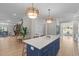 Kitchen island with seating and marble countertop overlooks the living space, creating an open floor plan at 2100 Summit St, Durham, NC 27707