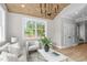 Cozy living room features light wood floors, modern furnishings, and a vaulted ceiling at 2100 Summit St, Durham, NC 27707