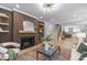 Cozy living room features a fireplace, modern decor, and a staircase leading to upper level at 2100 Summit St, Durham, NC 27707