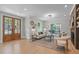 Spacious living room with hardwood floors, a modern light fixture, and a decorative rug at 2100 Summit St, Durham, NC 27707
