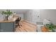 Comfortable office area with a modern desk, chair, hardwood floors, and natural light at 2100 Summit St, Durham, NC 27707