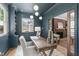 Stylish home office featuring built-in bookcase, natural light, and view into living room at 2100 Summit St, Durham, NC 27707