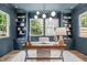 Stylish home office with built-in shelving, a large window, and a modern desk at 2100 Summit St, Durham, NC 27707