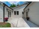 Wonderful patio with white brick, two doors, and flower pots at 2100 Summit St, Durham, NC 27707