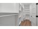 Spacious walk-in closet features custom shelving, wood floors, and ample storage space at 2100 Summit St, Durham, NC 27707
